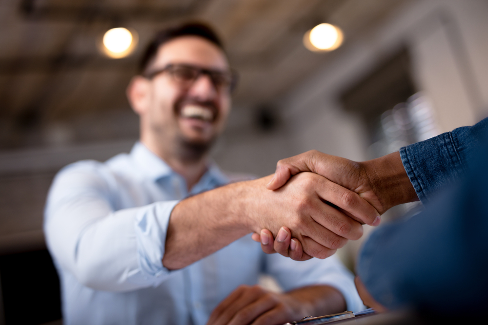 Businessmen in a handshake agreement in an office